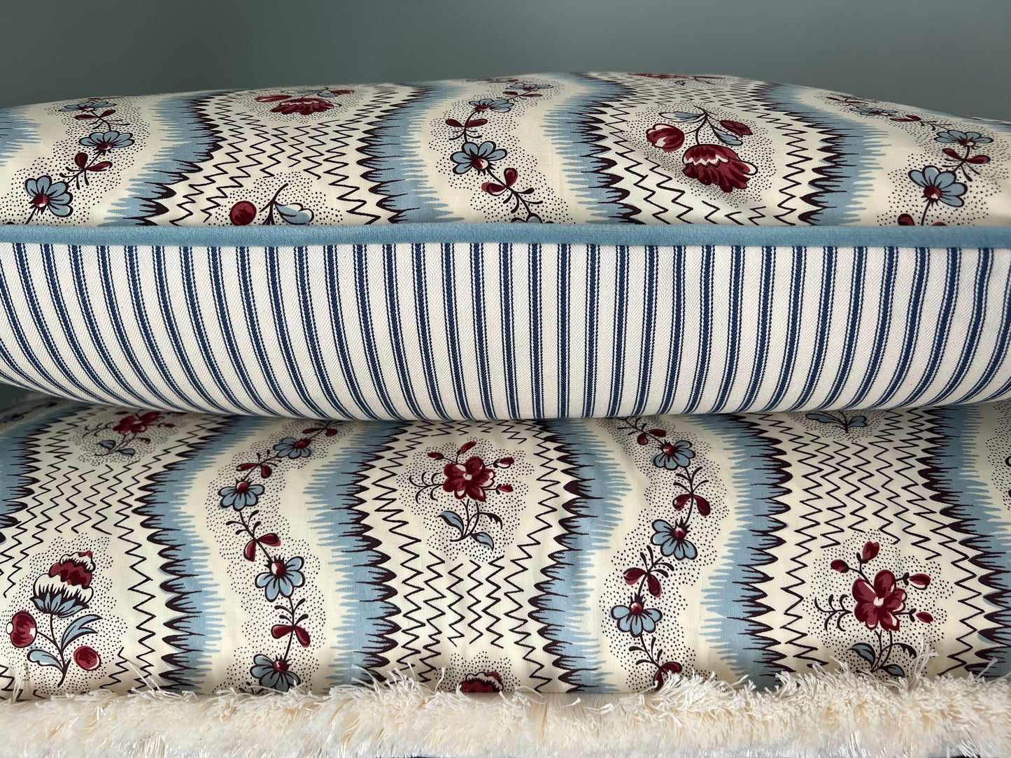 Cushions in Pierre Frey Le Manach Greuze fabric. Bleu Rouge colourway